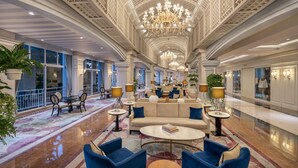 A spacious lobby with a high ceiling, chandeliers, seating areas, and large windows. - Rixos Premium Tekirova - The Land of Legends (Kemer)
