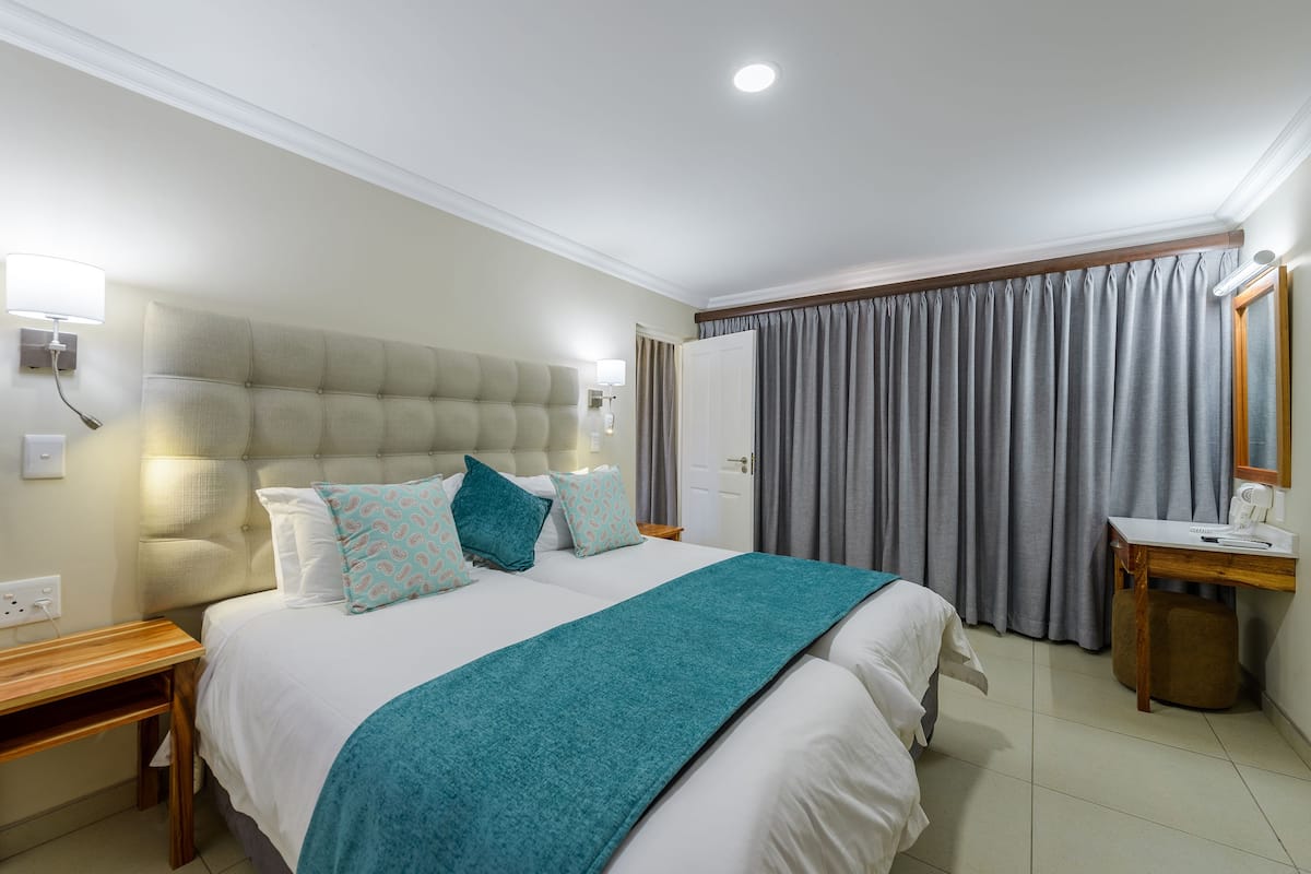 Family Suite with Patio | 2 bedrooms, in-room safe, individually furnished, bed sheets