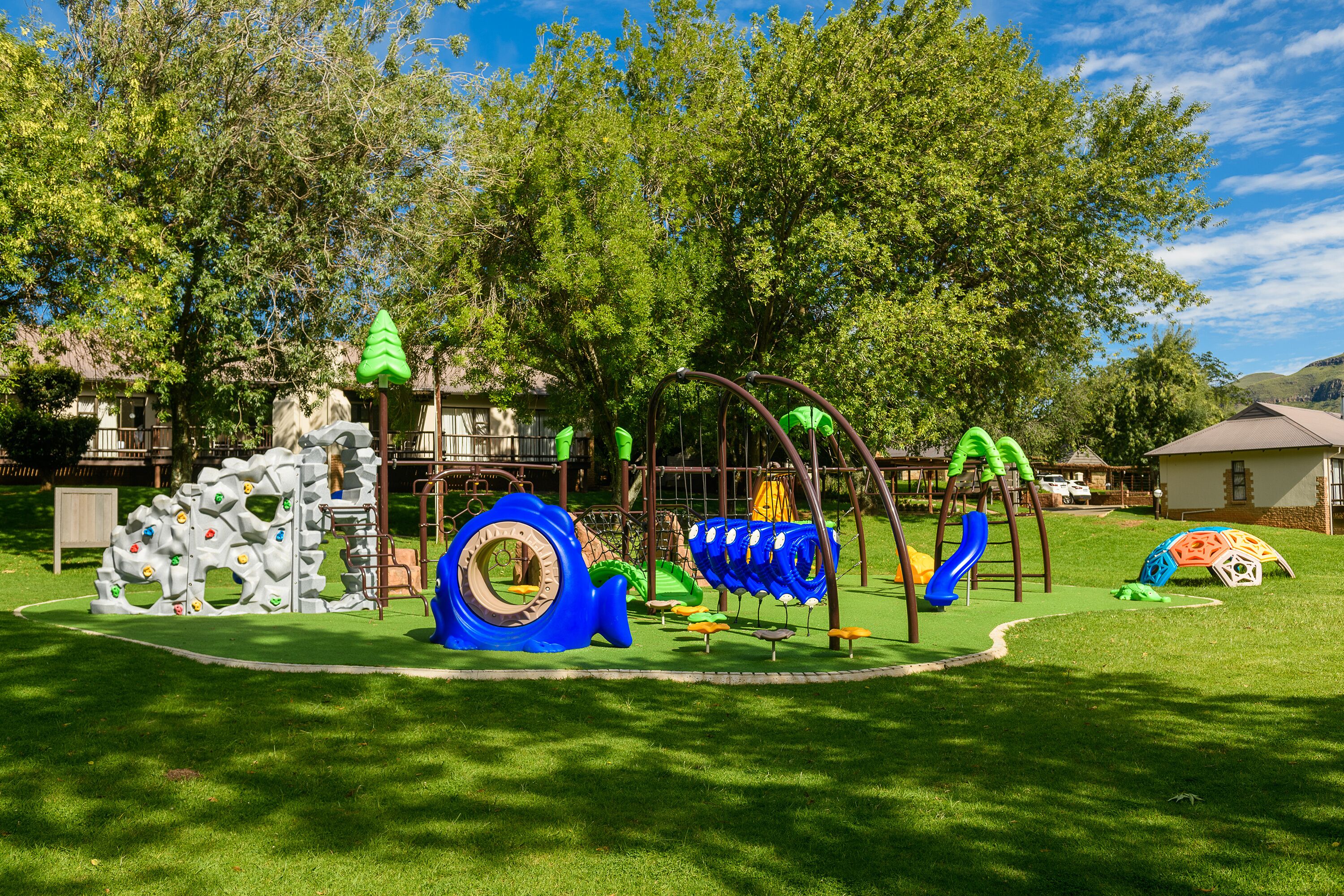 A playground with climbing structures, slides, and swings.