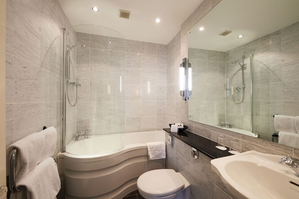 combined shower/bathtub, designer toiletries, hair dryer, bathrobes