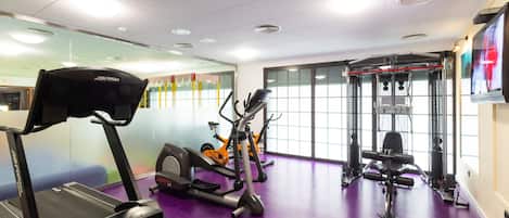 A gym with treadmills, an elliptical, and a weight machine.