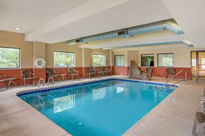 A pool area with chairs and a lifeguard chair, large windows, and a ceiling vent. - Best Western Danville Inn (Danville)
