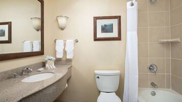 A bathroom with a sink, toilet, and bathtub.