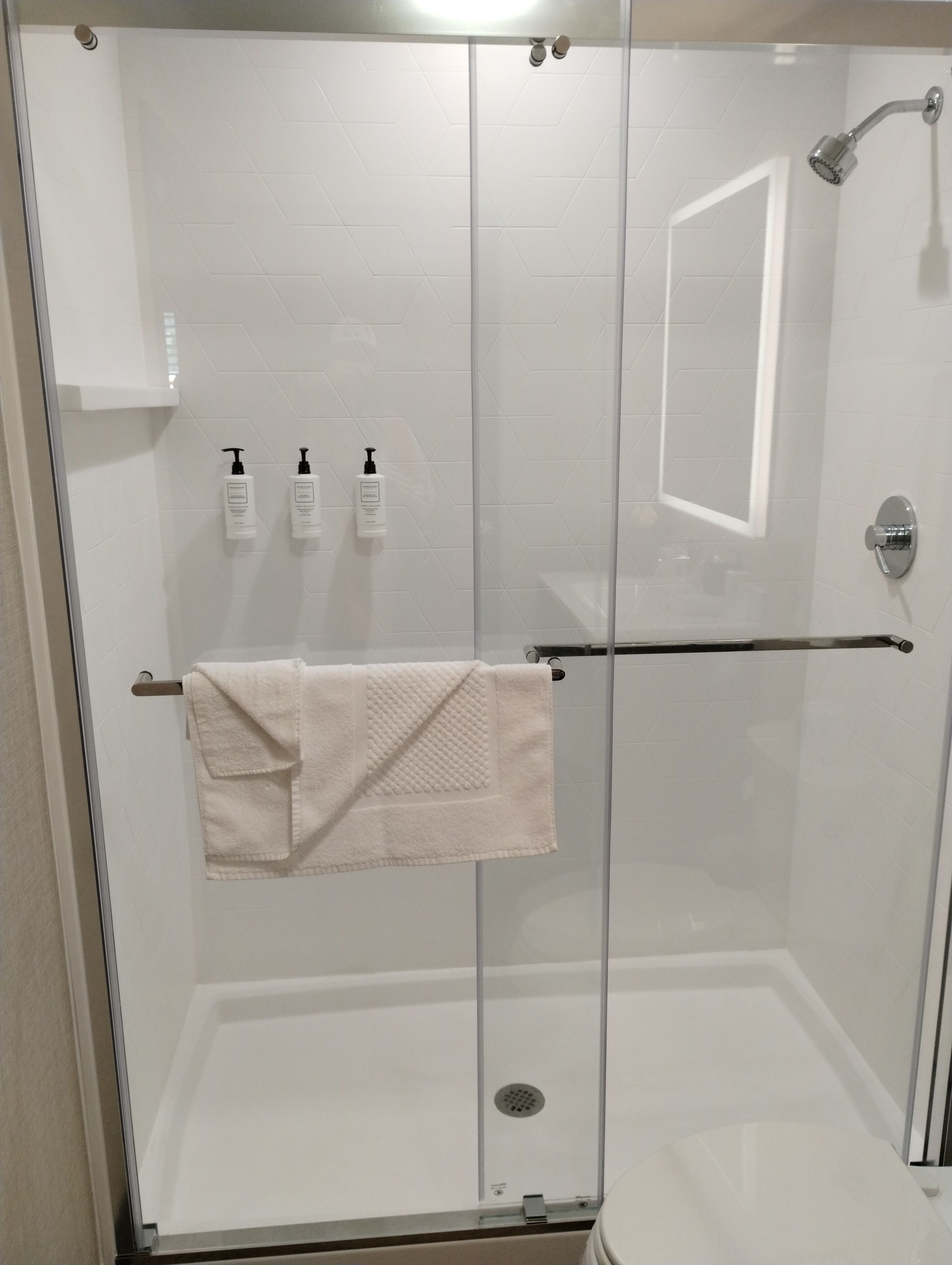 designer toiletries, hair dryer, towels