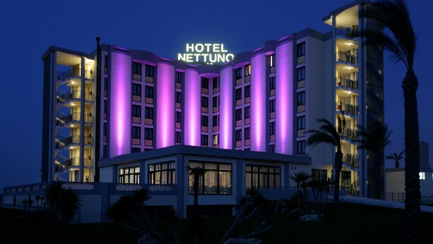 A multi-story hotel with a prominent sign reading "HOTEL NETTUNO."