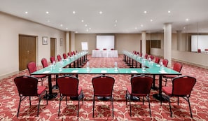 Meetings and presentations come alive in this well-equipped conference room with a long table, comfortable seating, and a whiteboard.