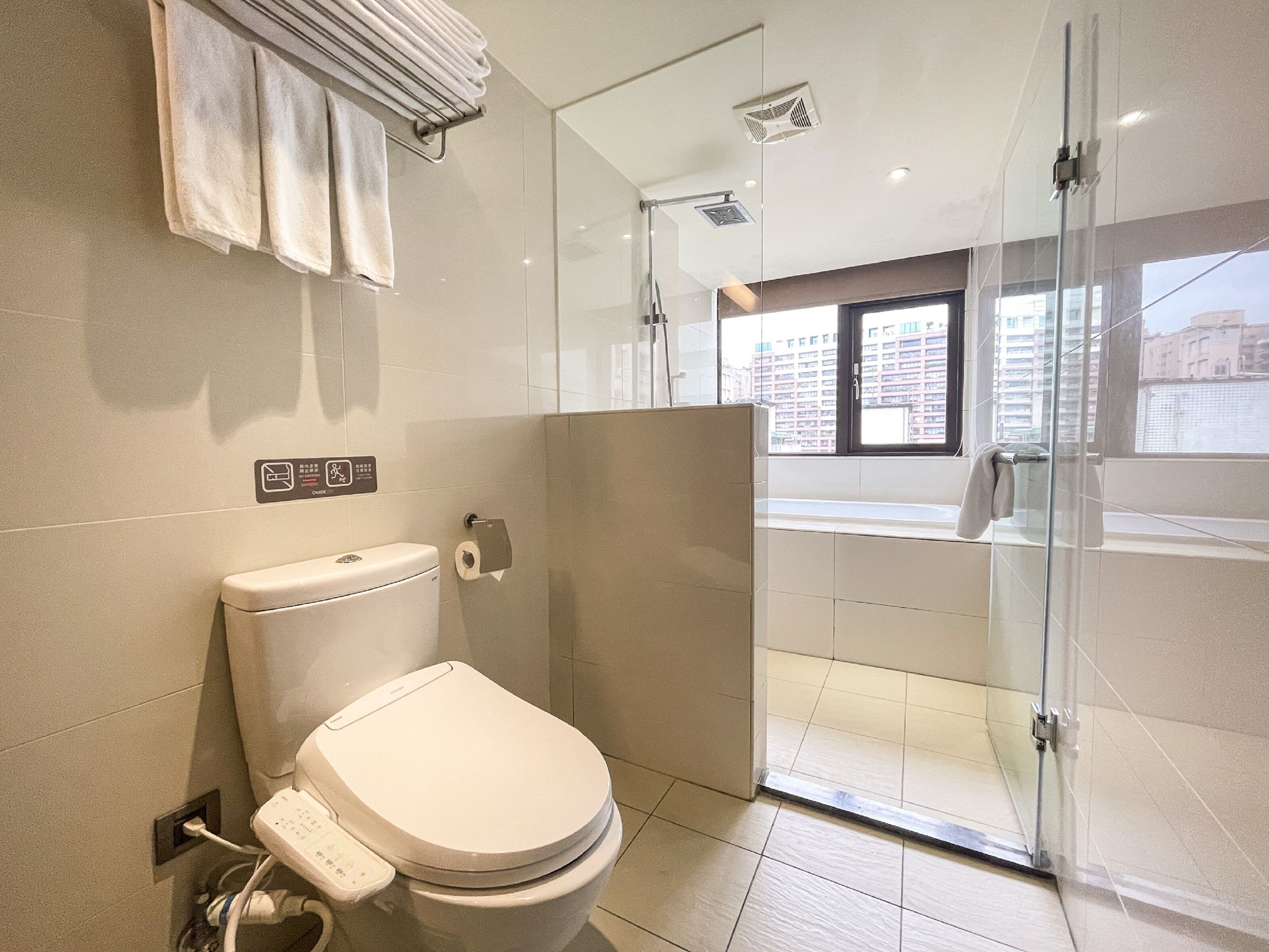 deluxe quadruple room | bathroom | hair dryer, towels, shampoo, toilet paper