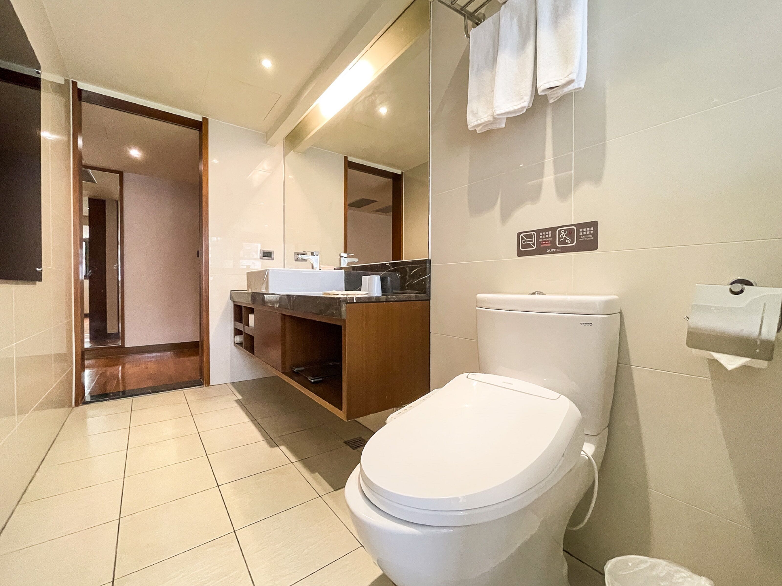 deluxe quadruple room | bathroom | hair dryer, towels, shampoo, toilet paper