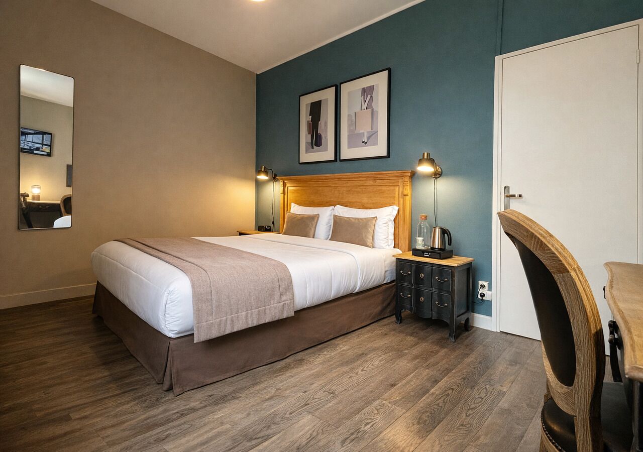A neatly arranged bedroom with a bed, bedside tables, a chair, and a door.