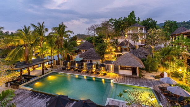 A resort with a swimming pool, thatched-roof structures, and lush greenery. - Aana Resort & Spa (Ko Chang)