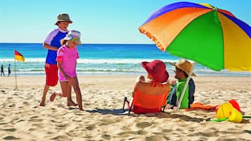 Guests can enjoy a relaxing beach day with a family-friendly atmosphere.