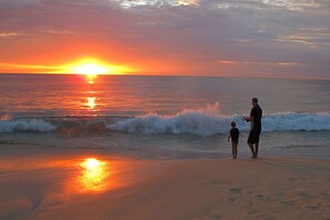 Beach nearby, white sand, beach towels, surfing