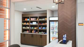 A snack bar with a variety of packaged foods and a refrigerated display.