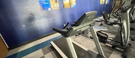 A gym with treadmills and exercise equipment.