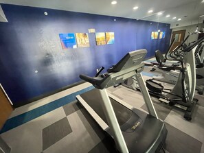A gym with treadmills and exercise equipment.