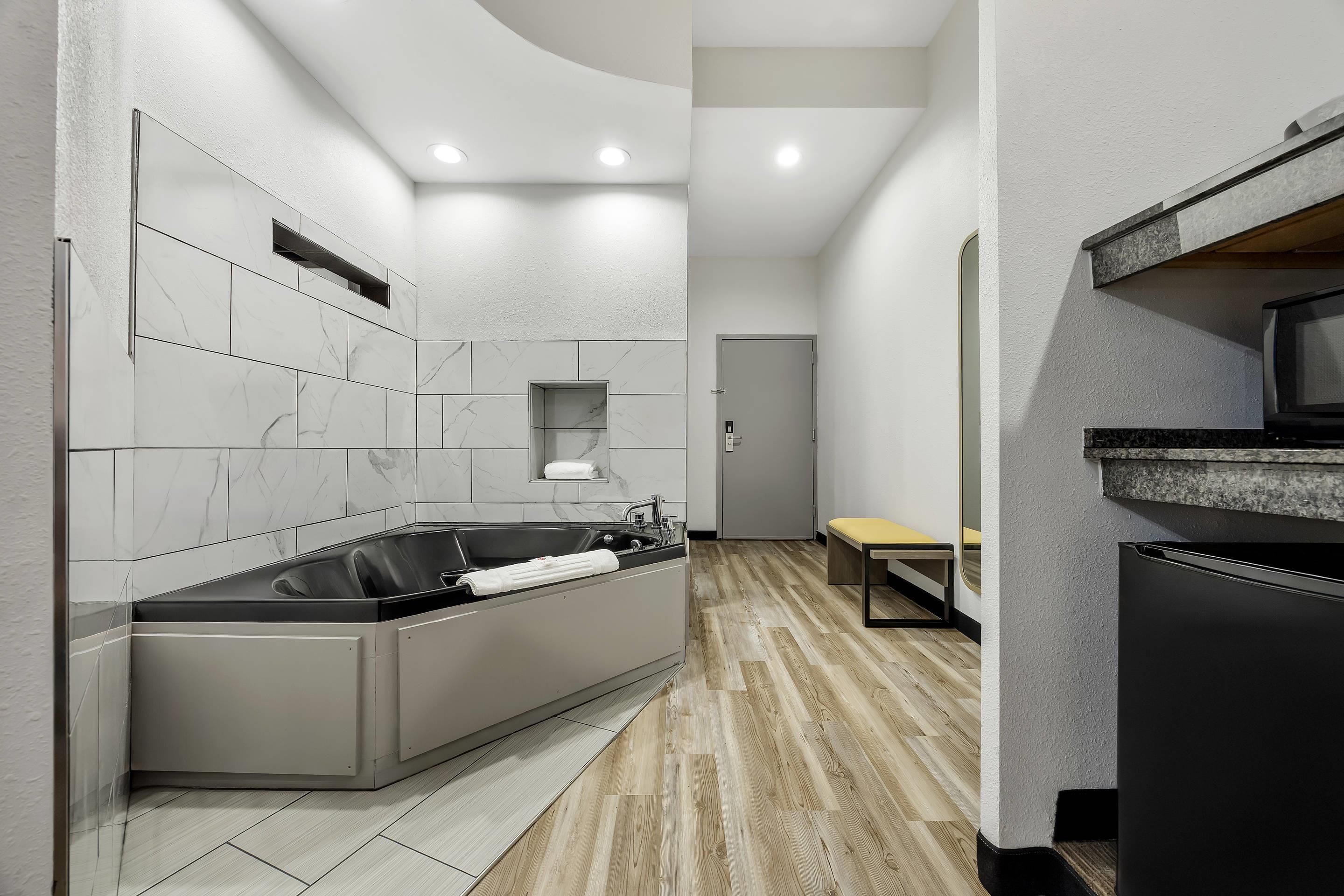 A modern kitchen with a built-in oven, a sink, and a bench.