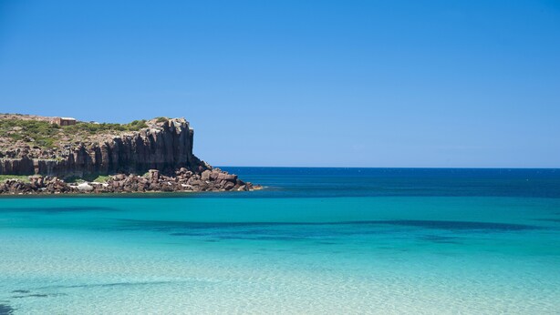 A coastal landscape with clear turquoise waters and rocky cliffs. - Lu' Hotel Carloforte (Carloforte)