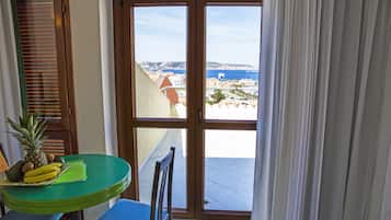 Comfort Triple Room, Sea View | Minibar, in-room safe, desk, blackout drapes