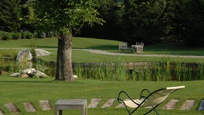 A park with a bench, a table, and a tree.