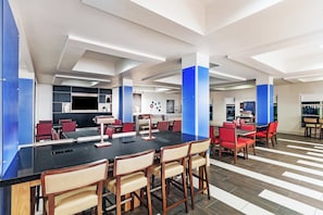 A modern conference room with a long table, red chairs, and a blue accent wall. - Holiday Inn Express & Suites Shreveport South Park Plaza by IHG (Shreveport)