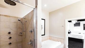 A modern bathroom with a shower, a bathtub, and a toilet.