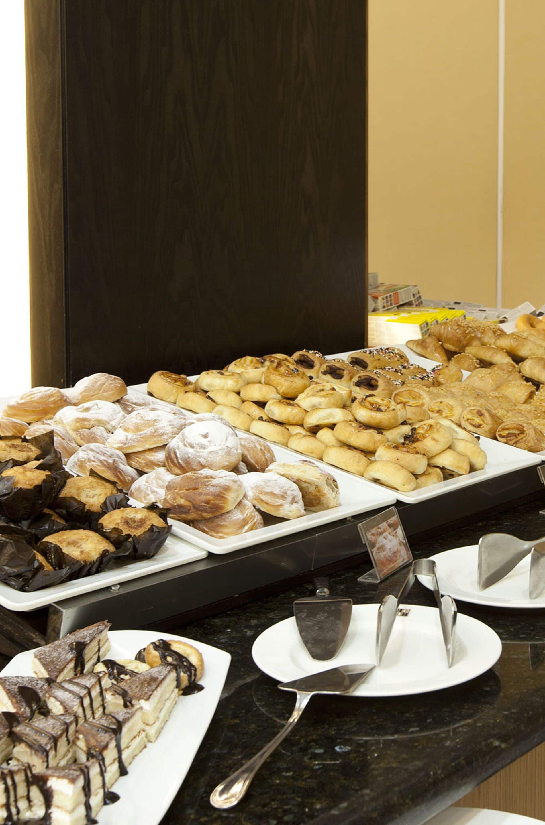 A buffet with various pastries and desserts.
