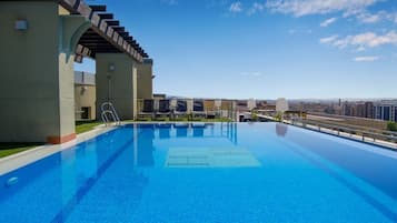 Seasonal outdoor pool, pool umbrellas, pool loungers