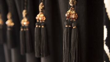 A close-up of black tassels hanging from a fabric surface.