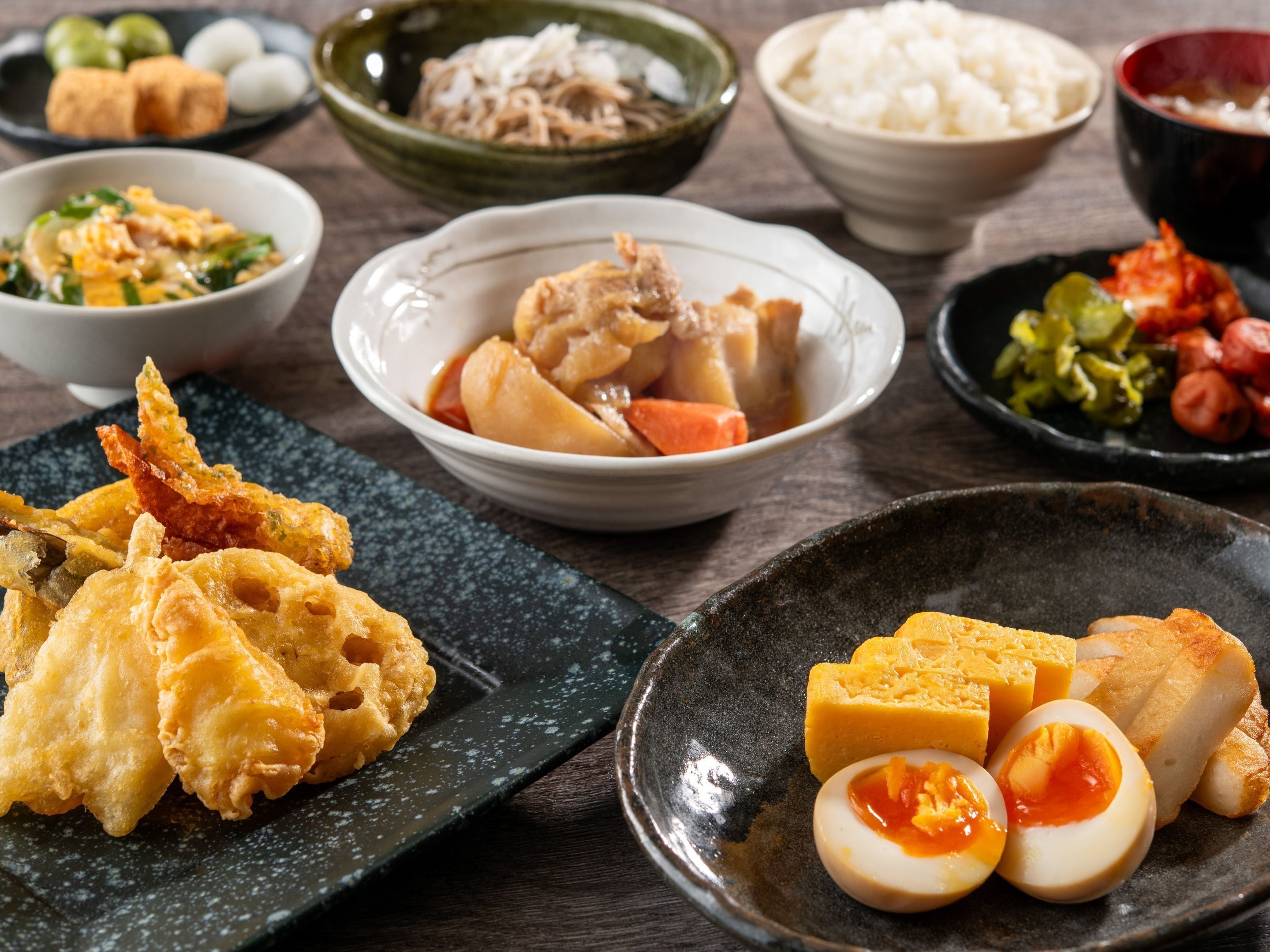 A variety of dishes including fried items, boiled eggs, and rice.