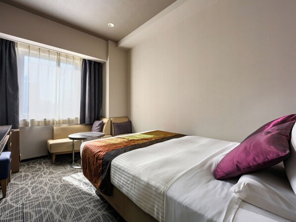 A hotel room with a bed, a desk, a chair, and a small table. - HOTEL MYSTAYS Ueno East (Tokyo)