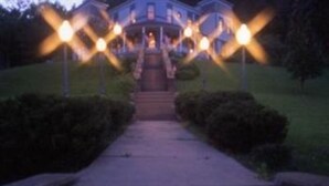A house with a front porch and steps leading up to it.