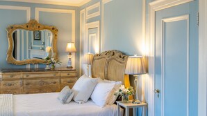 A bedroom with a bed, dresser, mirror, and bedside lamps. - The Kittle House Inn (Chappaqua)