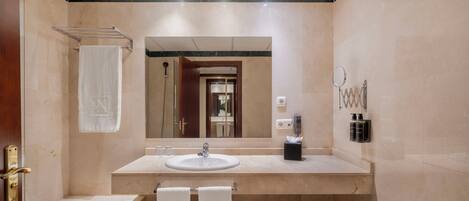A modern bathroom with a bathtub, a sink, and a mirror.