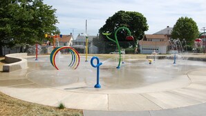 A water park with multiple water features and a circular concrete play area.
