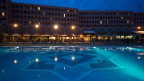 A hotel with a large pool featuring a geometric pattern, multiple balconies, and a uniform architectural style. - Atlas Asni (Marrakech)