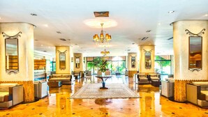 A spacious lobby with a polished marble floor, a central table, and seating areas. - Atlas Asni (Marrakech)