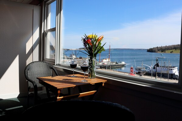 Oceanfront Honeymoon King Room with Sunporch | Living area | Flat-screen TV - Rum Runner Inn (Lunenburg)