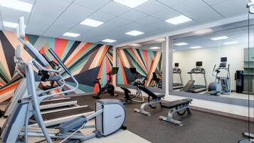 A gym with treadmills, ellipticals, and weight machines.
