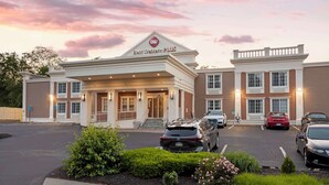 A hotel with a prominent 'Best Western Plus' sign, a parking lot with several cars, and a landscaped entrance area. - Best Western Plus Fairfield Hotel (Fairfield)