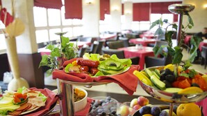 Un bufé con diversas frutas, verduras y carnes.