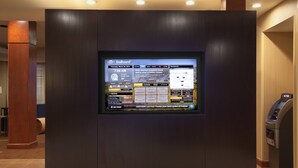 A digital display in a lobby with a GoBoard interface, including a weather forecast, news, and a map. - Courtyard by Marriott Grand Junction (Grand Junction)