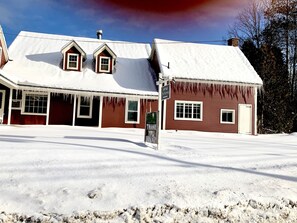 A snow-covered building with a sign reading "The Mudmeg." - The Nutmeg (Wilmington)