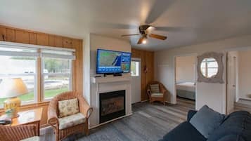 A living room with a fireplace, television, and seating area.