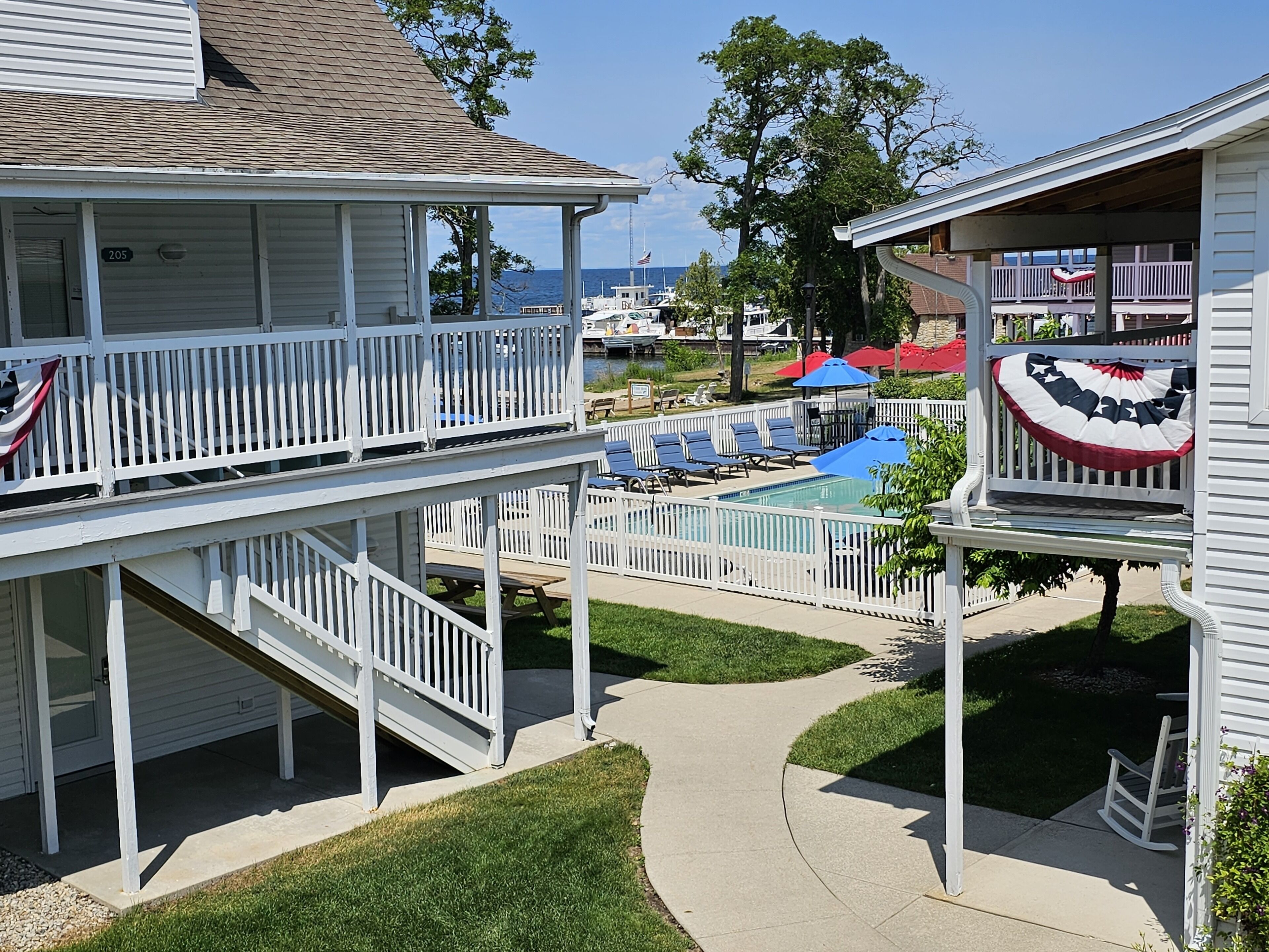 A two-story house with a balcony and a pool area.