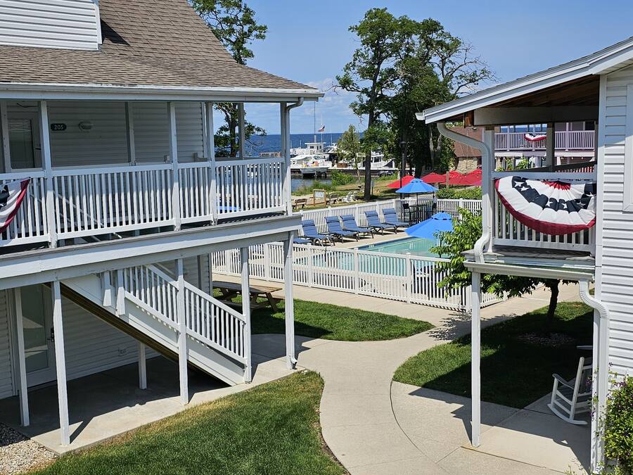 A two-story house with a balcony and a pool area.