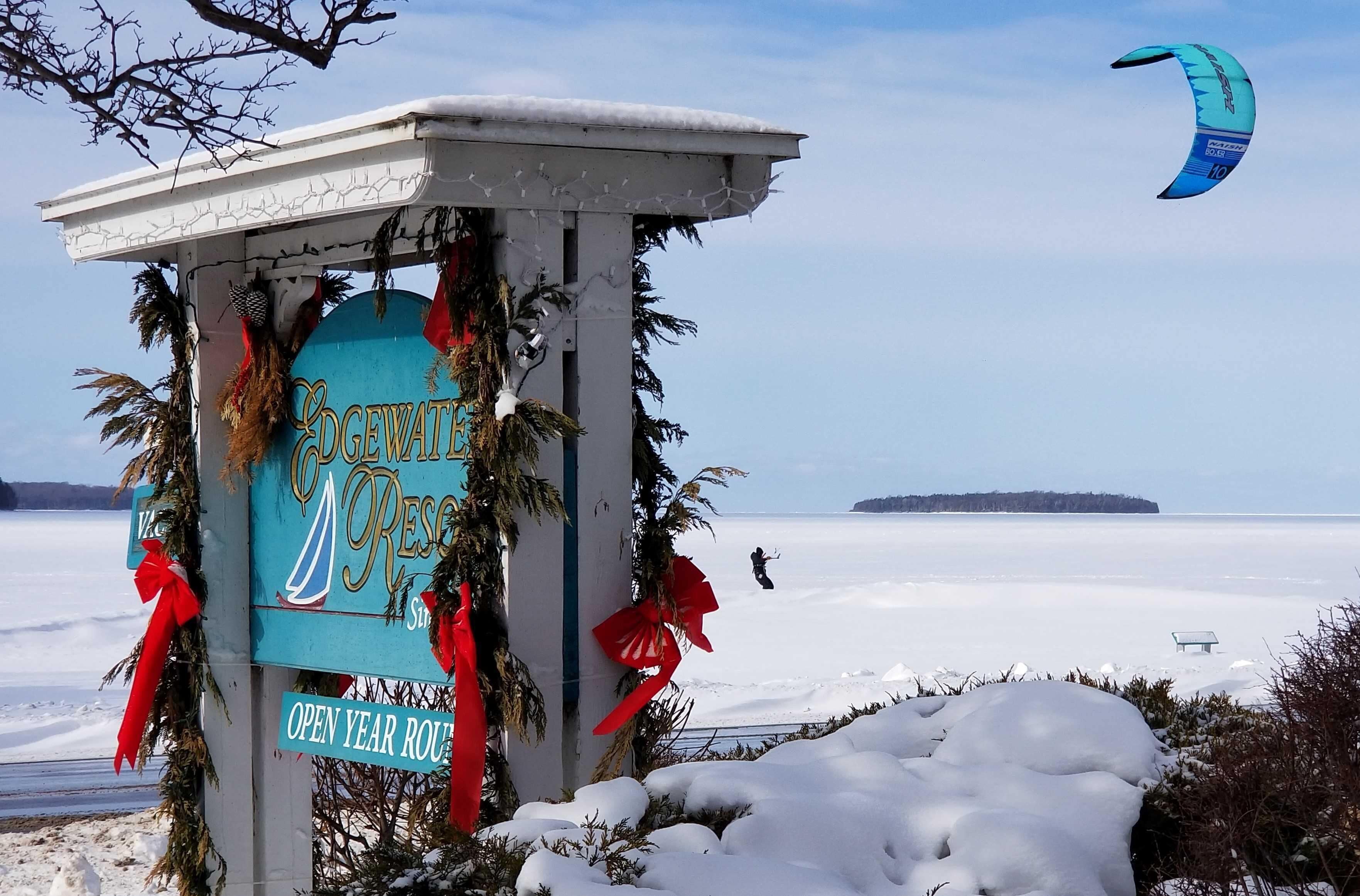 A gazebo with a sign reading "Gevatim Resort" and "Open Year Round" surrounded by snow.