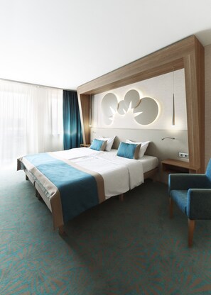 A hotel room with a large bed, two bedside tables, a chair, and a decorative wall panel. - Hotel Európa Fit (Hévíz)