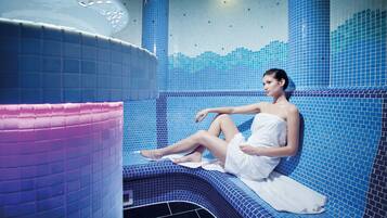 Relax in a serene space with a curved bench against a mosaic-tiled wall, complemented by a calming water feature.