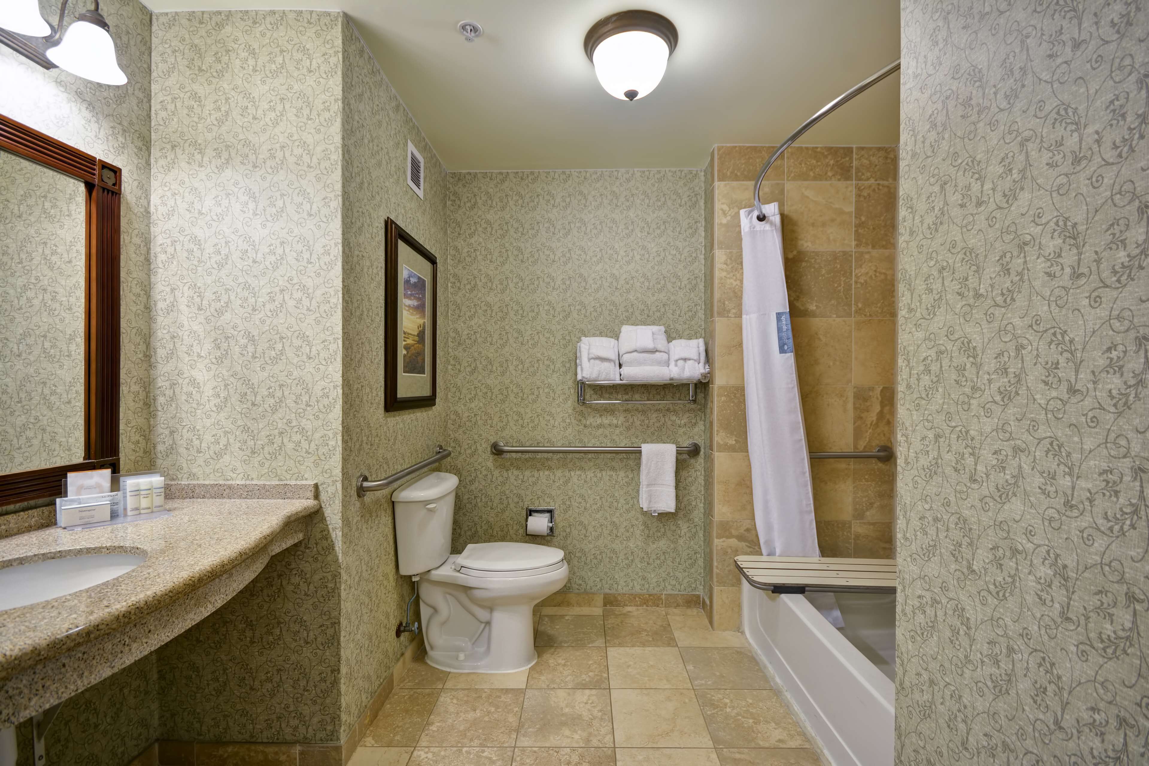A bathroom with a sink, toilet, and shower.