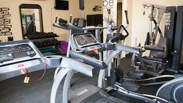 A gym with treadmills, elliptical machines, and weight machines.